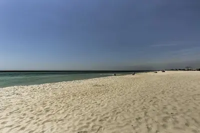 a sandy beach with the ocean in the background at Beachfront Panama City Condo with Balcony and Views! in Panama City