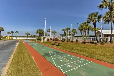 a basketball court in a park with palm trees at Beachfront Panama City Condo with Balcony and Views! in Panama City