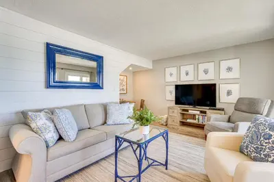 a living room with a couch and a tv at Beachfront Panama City Condo with Balcony and Views! in Panama City