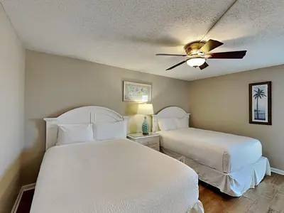 a bedroom with two beds and a ceiling fan at Edgewater Tower Iii 1111 in Panama City Beach