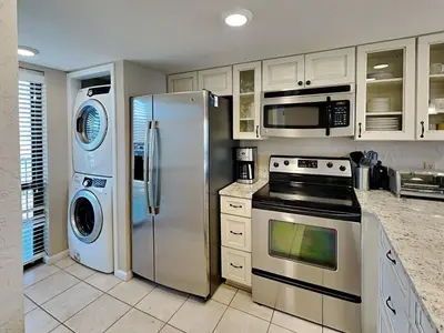a kitchen with a stainless steel refrigerator and appliances at Edgewater Tower Iii 1111 in Panama City Beach
