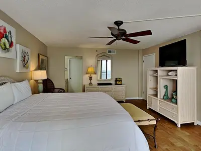 a bedroom with a white bed and a ceiling fan at Edgewater Tower Iii 1111 in Panama City Beach