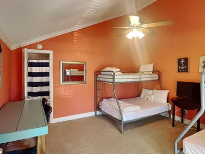 a room with two bunk beds and a ceiling fan at Horizon South #31A in Panama City Beach