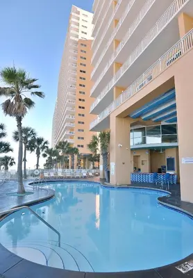 a large swimming pool in front of a building at Beachfront Oasis at Splash Resort and Condos in Panama City Beach