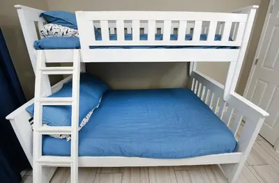 a white bunk bed with a blue mattress at Beachfront Oasis at Splash Resort and Condos in Panama City Beach