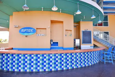 a stage in a building with a sign that reads ripride at Beachfront Oasis at Splash Resort and Condos in Panama City Beach