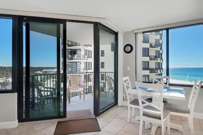 a dining room with a view of the ocean at Sunbird 601W in Panama City Beach