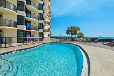 a swimming pool in front of a apartment building at Sunbird 601W in Panama City Beach