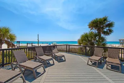 a deck with chairs and the beach in the background at Sunbird 601W in Panama City Beach