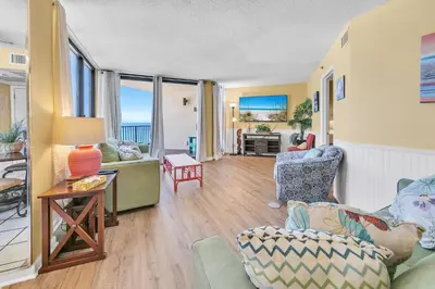 a living room with chairs and a table at Sunbird 906W in Panama City Beach