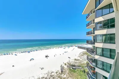 a view of the beach from the balcony of a building at Sunbird 906W in Panama City Beach