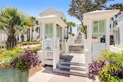 a white house with green shutters at Lily Pad in Panama City Beach