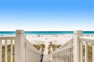 a stairway to the beach with the ocean in the background at Lily Pad in Panama City Beach