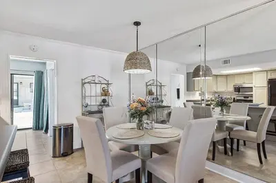 a dining room and kitchen with a table and chairs at The Original Robin's Nest/ 5 Min Walk To The Beach in Panama City Beach