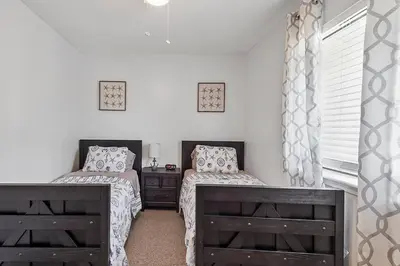 a bedroom with two twin beds and a window at The Original Robin's Nest/ 5 Min Walk To The Beach in Panama City Beach