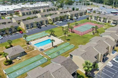 an aerial view of a apartment complex with a tennis court at The Original Robin's Nest/ 5 Min Walk To The Beach in Panama City Beach