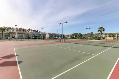 a tennis court with two tennis courts at The Original Robin's Nest/ 5 Min Walk To The Beach in Panama City Beach
