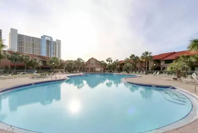 a large swimming pool at a resort at The Original Robin's Nest/ 5 Min Walk To The Beach in Panama City Beach