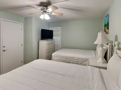 a bedroom with two beds and a ceiling fan at Edgewater Tower Ii 403 in Panama City Beach