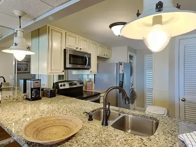 a kitchen with a sink and a counter top at Edgewater Tower Ii 403 in Panama City Beach