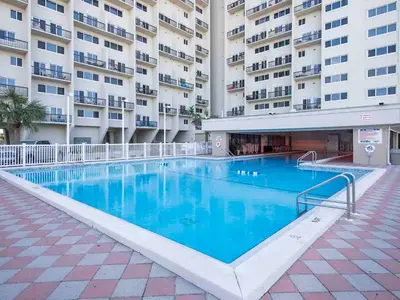 a large swimming pool in front of a building at Pinnacle Port a-702 in Panama City Beach