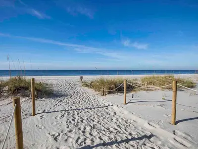 a sandy beach with a net in the sand at Pinnacle Port a-702 in Panama City Beach