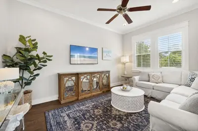 a living room with a couch and a ceiling fan at Coastal Cottage at 30A in Inlet Beach