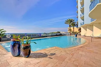 a swimming pool with two large pots with plants in it at Sterling Breeze 1507 in Panama City Beach