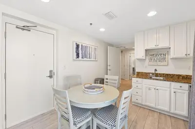 a kitchen and dining room with a table and chairs at Sterling Breeze 1507 in Panama City Beach