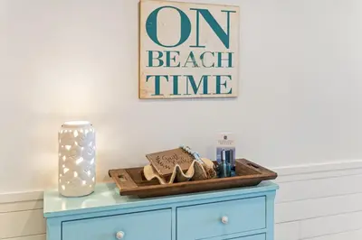 a table with a wooden tray with sandals on it at Sterling Breeze 1507 in Panama City Beach