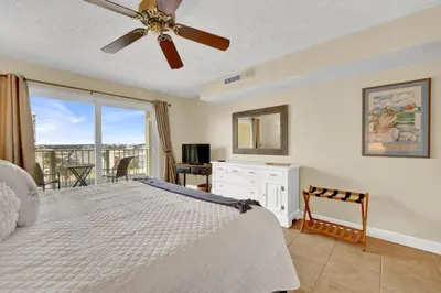 a bedroom with a bed and a ceiling fan at Regency Towers 404 in Panama City Beach