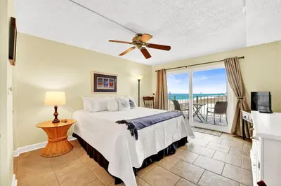 a bedroom with a bed and a view of the ocean at Regency Towers 404 in Panama City Beach