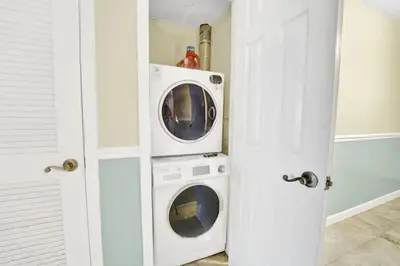 a washer and dryer in a white room at Regency Towers 404 in Panama City Beach