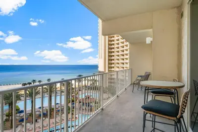 a balcony with a table and chairs and the ocean at Gulf-Front Shores of Panama Condo w/ Balcony & Resort Amenities in Panama City Beach