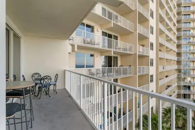 a balcony of a apartment building with a table and chairs at Gulf-Front Shores of Panama Condo w/ Balcony & Resort Amenities in Panama City Beach