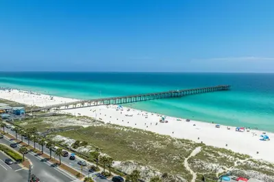 an aerial view of a beach with a pier at Gulf-Front Shores of Panama Condo w/ Balcony & Resort Amenities in Panama City Beach