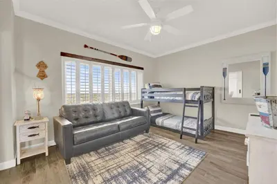 a living room with a couch and a bunk bed at Coral Reef 1001 in Panama City Beach