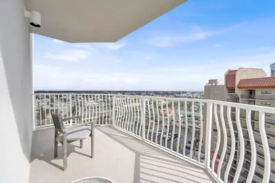a balcony with a chair and a view of the ocean at Coral Reef 1001 in Panama City Beach