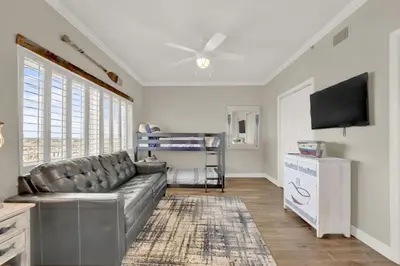 a living room with a couch and a flat screen tv at Coral Reef 1001 in Panama City Beach