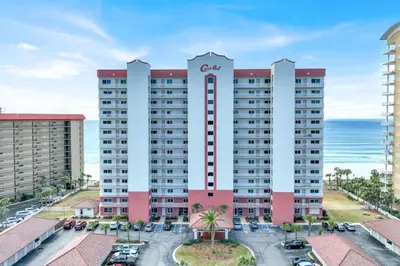 a large apartment building with the ocean in the background at Coral Reef 1001 in Panama City Beach