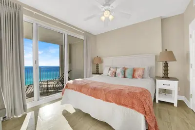 a bedroom with a bed with a view of the ocean at Family-Friendly 4BR Beachfront Retreat w/ Indoor & Outdoor Pools in Panama City Beach