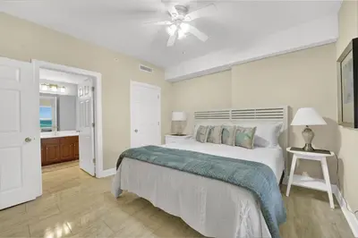 a bedroom with a bed and a ceiling fan at Family-Friendly 4BR Beachfront Retreat w/ Indoor & Outdoor Pools in Panama City Beach