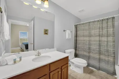 a bathroom with a sink and a toilet and a shower at Family-Friendly 4BR Beachfront Retreat w/ Indoor & Outdoor Pools in Panama City Beach