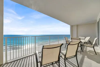 a balcony with chairs and a view of the ocean at Family-Friendly 4BR Beachfront Retreat w/ Indoor & Outdoor Pools in Panama City Beach