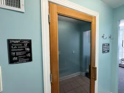 a door to a bathroom with a sign on the wall at Family-Friendly 4BR Beachfront Retreat w/ Indoor & Outdoor Pools in Panama City Beach