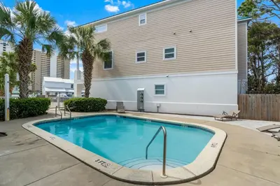 a swimming pool in front of a building at Emerald Coast Villa in Panama City Beach