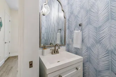 a bathroom with a sink and a mirror at Emerald Coast Villa in Panama City Beach