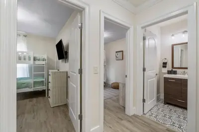 a room with a bathroom with a sink and a mirror at Emerald Coast Villa in Panama City Beach