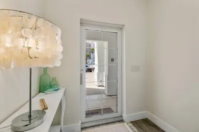 a hallway with a glass door leading to a room at Emerald Coast Villa in Panama City Beach