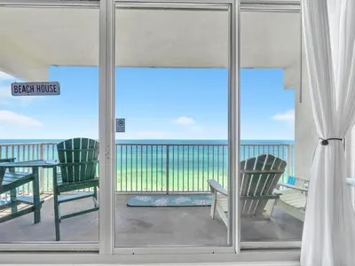 a view of the ocean from a balcony with two chairs at Shores of Panama 1002 in Panama City Beach